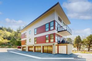 a large building with a balcony on top of it at Stunner apt with fireplace grill partial ocean views & partial AC in Gold Beach