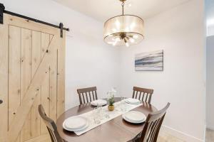 a dining room with a table with chairs and a chandelier at Stunner apt with fireplace grill partial ocean views & partial AC in Gold Beach +23 photos