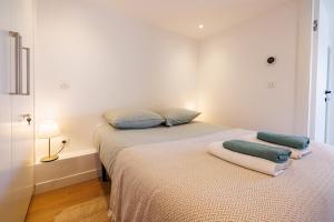 a bedroom with a bed with two pillows on it at Apt Le Frene in Tourrettes-sur-Loup