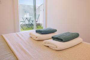 two towels are sitting on top of a bed at Apt Le Frene in Tourrettes-sur-Loup +18 photos