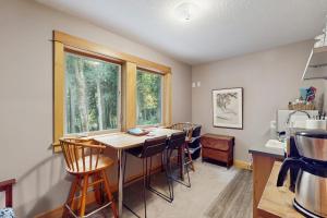 a kitchen with a table and chairs in a room at Charming riverfront apartment with kitchenette grill & central AC in Welches