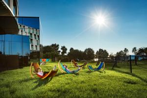 a group of children laying in lawn chairs in the grass at Maistra Select Family Hotel Amarin in Rovinj