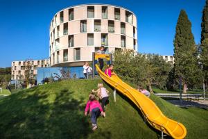 a group of children playing on a slide in a park at Maistra Select Family Hotel Amarin in Rovinj