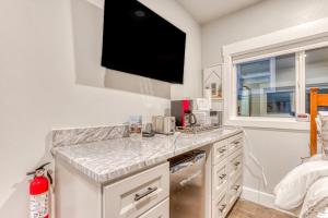 a kitchen with a counter with a tv on the wall at Inviting studio with kitchenette & scenic forest setting in Welches