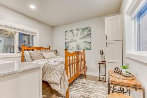 a bedroom with a crib and a bed in a room at Inviting studio with kitchenette & scenic forest setting in Welches +5 photos