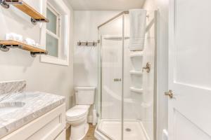 a white bathroom with a toilet and a shower at Inviting studio with kitchenette & scenic forest setting in Welches