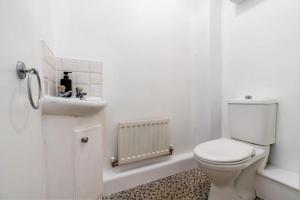 a white bathroom with a toilet and a sink at Hills Close - 3 Bed House - FREE Parking in Mexborough +34 photos