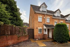 a brick house with a fence in front of it at Hills Close - 3 Bed House - FREE Parking in Mexborough