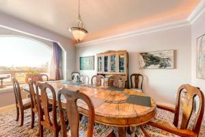 a dining room with a wooden table and chairs at Stunning Spacious Riverfront House with Private Sauna in Florence
