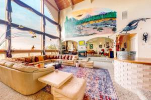 a large living room with couches and a large window at Stunning Spacious Riverfront House with Private Sauna in Florence