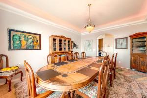 a dining room with a wooden table and chairs at Stunning Spacious Riverfront House with Private Sauna in Florence +50 photos