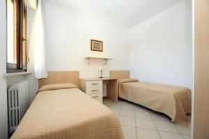 Postel nebo postele na pokoji v ubytování Residence Sole del Conero