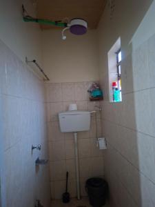 a small bathroom with a toilet and a window at Larmar Homes- Kajiado in Kajiado
