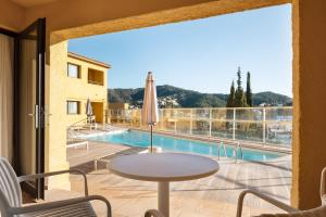 a patio with a table and a view of a pool at Feelathome Vil-la Romana in Tossa de Mar +71 photos