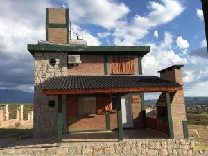 a small brick building with a tower on top at Complejo Las Carolina in Arroyo de Los Patos