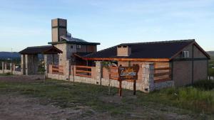 a building with a sign in front of it at Complejo Las Carolina in Arroyo de Los Patos
