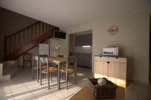 a kitchen and dining room with a table and a microwave at Orient Village in Géraudot