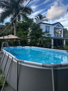 a swimming pool in front of a house at La Villa Allamanda in Rodrigues Island