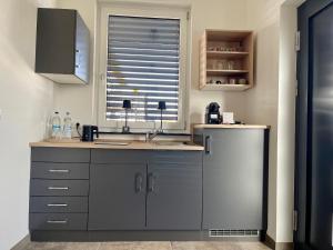 a kitchen with a sink and a window at Villa Kunterbunt in Bad Staffelstein +7 photos