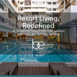 a swimming pool in a building with the words resort living redefined at BE Residences Lahug in Cebu City