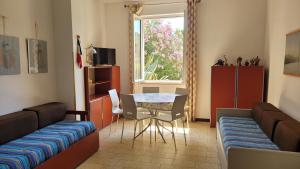 a room with a bed and a table and a window at Elba in relax in Rio Marina