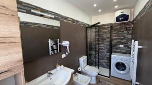 a bathroom with a toilet sink and a washing machine at Un Tuffo nello Stretto in Villa San Giovanni +33 photos