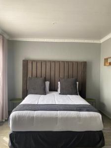 a bedroom with a large bed with two pillows at Yandheya Guest House in Calcutta +48 photos