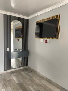 a bathroom with a sink and a mirror at Yandheya Guest House in Calcutta