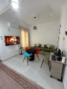 a living room with a couch and a table and chairs at Casa Shala in Tunis