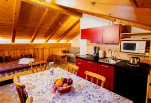 a kitchen with a table with a bowl of fruit on it at Chalet Presanella in Temù