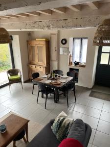 a living room with a table and a couch at Gîte de la Pisserotte in Montigny-sur-Armançon