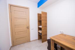 a room with a closet with a wooden door at The Best Hostel in Yerevan