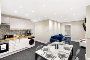a kitchen and living room with a table and chairs at Spacious 2-Bed Home in Chipping Barnet in Barnet