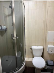 a bathroom with a toilet and a glass shower at Fly Apart in (( Turksib ))