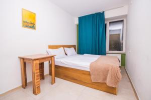 a bedroom with a bed with a table and a window at The Best Hostel in Yerevan