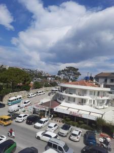 a parking lot with cars parked in front of a building at Çeşme MASAL in Çeşme