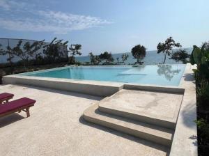 a swimming pool with a purple bench next to it at Paida Moyo Ocean Breeze Apartment in Zanzibar City