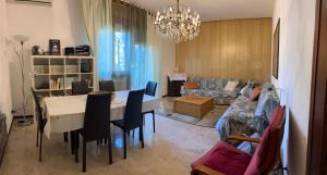 a living room with a table and chairs and a couch at Paolo&SilviaHost in Seriate +19 photos