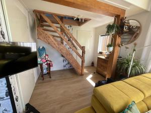 a living room with a staircase and a couch at Janka B&B in Elim