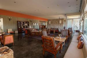 a restaurant with tables and chairs in a room at Hotel Territorio in Puerto Madryn +62 photos