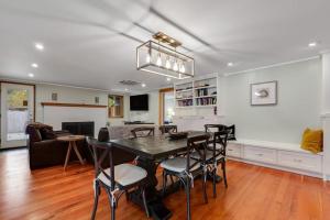 a dining room and living room with a table and chairs at The Entire Property at Mount Walker Inn in Quilcene