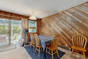 a dining room with a table and chairs at Spacious home with full kitchen wifi private backyard & grill in Welches