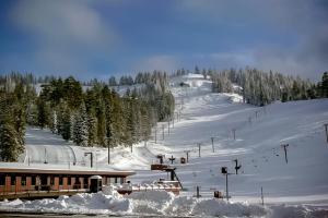 a snow covered ski slope with a ski lift at Comfortable condo with shared pool SHARC passes trails and more in Sunriver