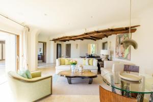 a living room with a couch and a table at Hotel Pitrizza, Costa Smeralda in Porto Cervo