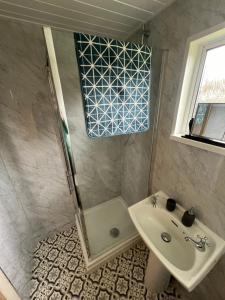a bathroom with a shower and a sink at Cromer Coastal Retreat Kings Chalet Park in Cromer +3 photos