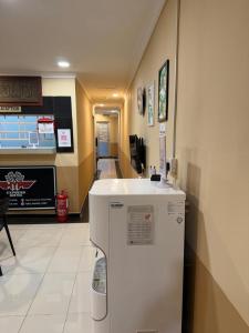 a room with a white refrigerator in a store at Jam Hotel Nilai in Nilai