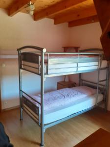 a bunk bed room with two bunk beds at La grange des chouettes in Ilheu