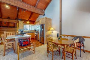 a kitchen and dining room with a table and chairs at Cozy condo with mountain views free shuttle & W&D in Ponderosa Fairway Estates +27 photos