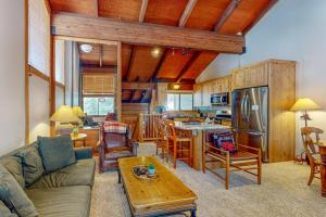 a living room with a couch a table and a kitchen at Cozy condo with mountain views free shuttle & W&D in Ponderosa Fairway Estates