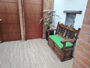 a room with a chair and a fireplace at Salon de eventos cabaña el Chalet in Paipa +3 photos